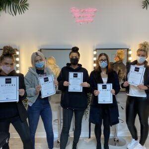 five students with certificates after completing fast track lash training